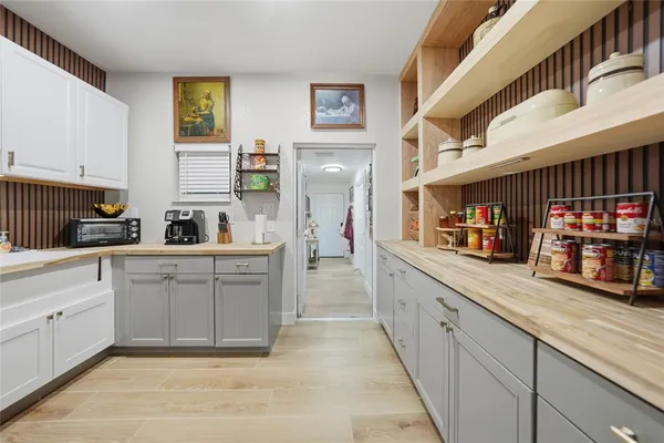 a kitchen with white cabinets and sink