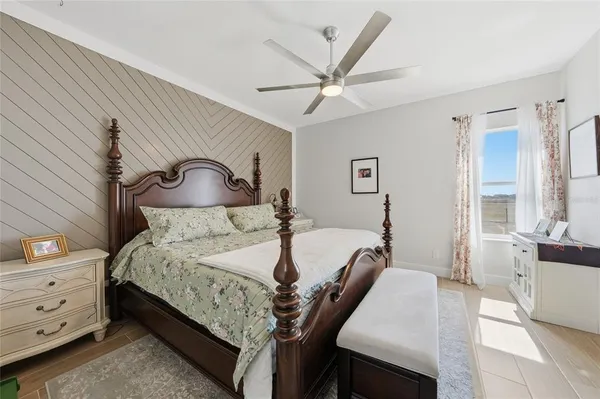 a bedroom with a bed and a chandelier