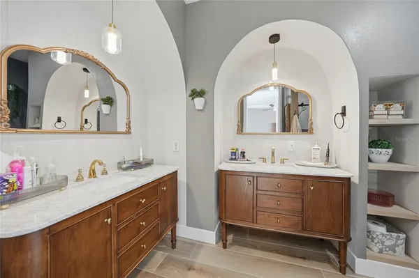a bathroom with a granite countertop sink mirror vanity and toilet