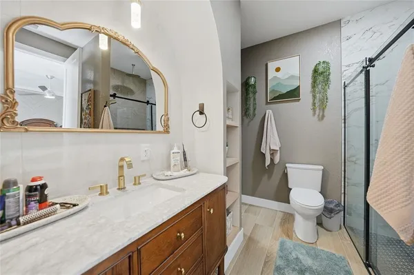 a bathroom with a sink mirror and vanity