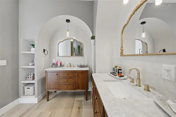 a bathroom with a sink a vanity and a mirror