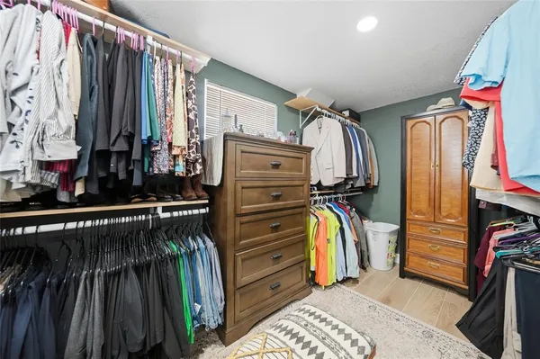 a bedroom with a bed and a dresser in it