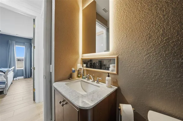 a bedroom with a bed and lamps