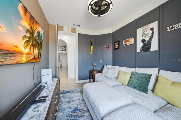 a living room with furniture and a bookshelf