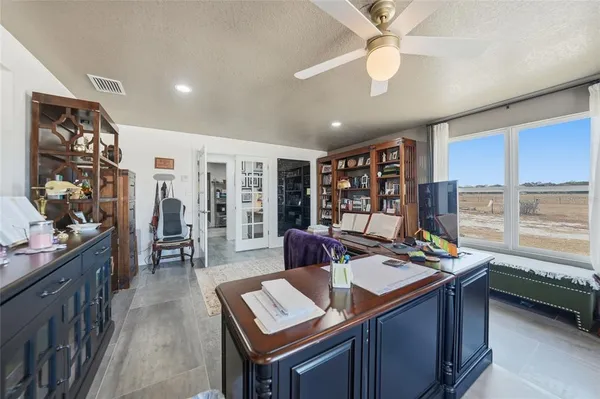 a view of a hallway and a livingroom with furniture