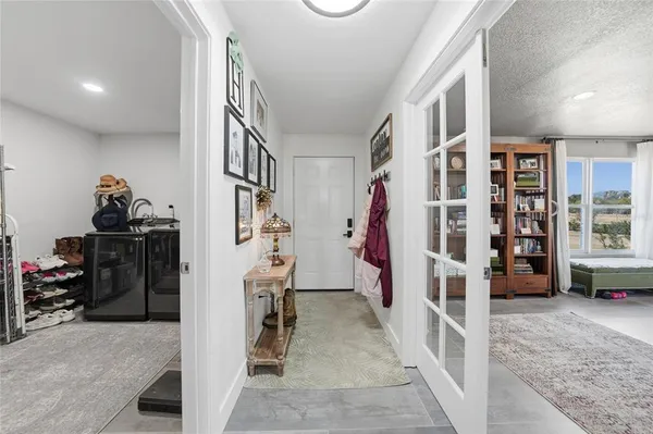 a view of a backyard with couches potted plants and wooden floor