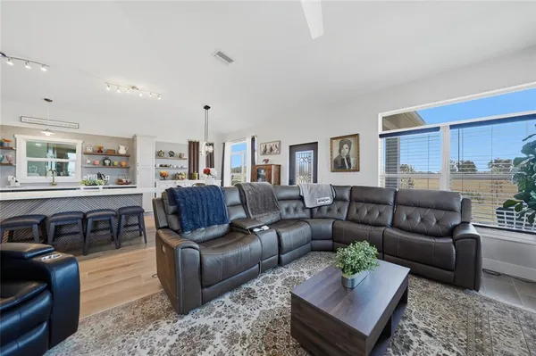 a living room with furniture wooden floor and a window