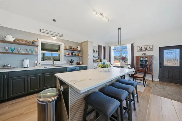 a kitchen with kitchen island granite countertop lots of counter top space and sink