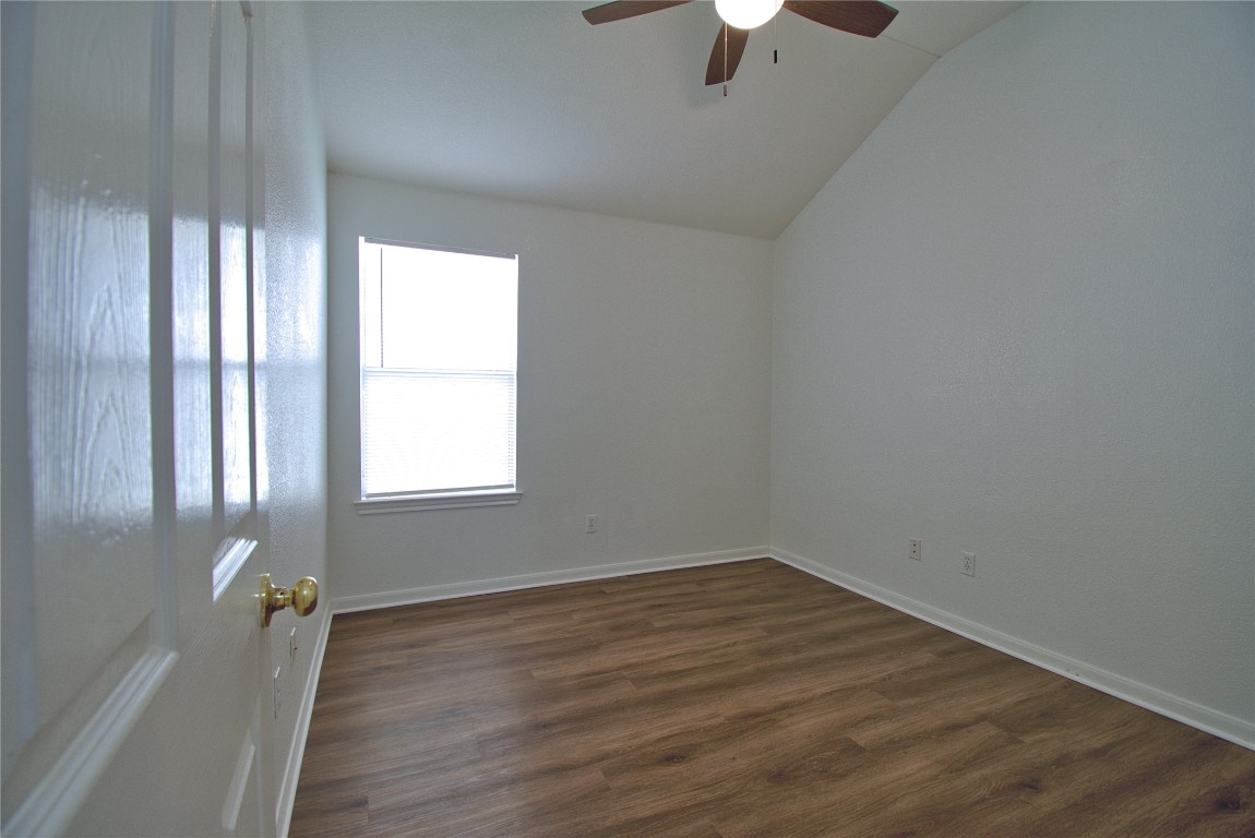 120 Greenside Lane Georgetown, TX 78633 - Photo 12 of 27 wooden floor in an empty room with a window