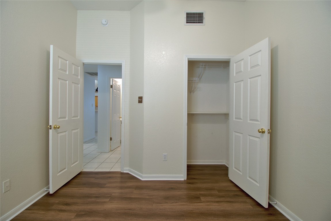 120 Greenside Lane Georgetown, TX 78633 - Photo 15 of 27 an empty room with wooden floor & closet area