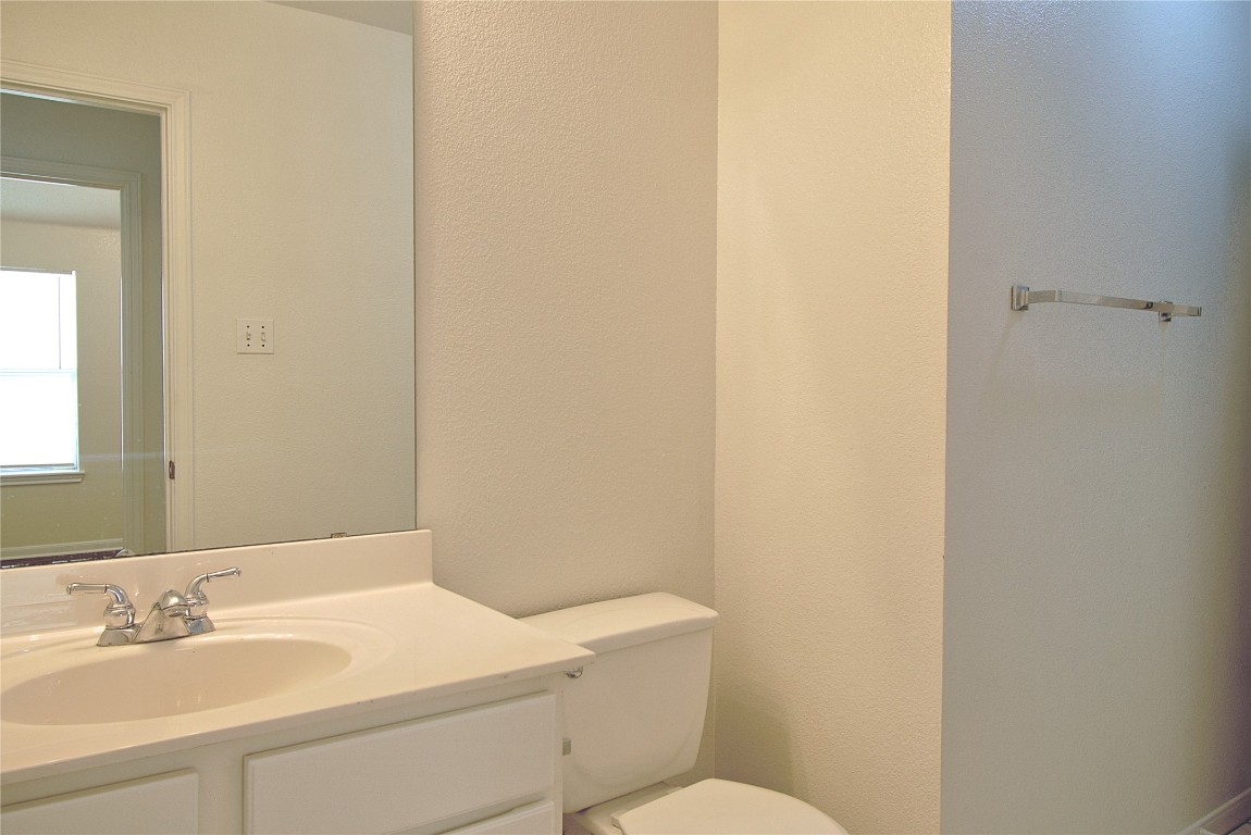 120 Greenside Lane Georgetown, TX 78633 - Photo 16 of 27 a bathroom with a sink a toilet and a mirror