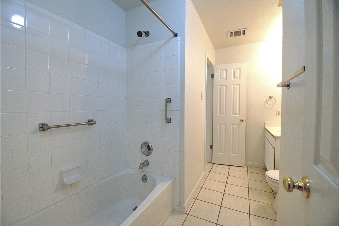 120 Greenside Lane Georgetown, TX 78633 - Photo 17 of 27 a bathroom with a bathtub shower and toilet