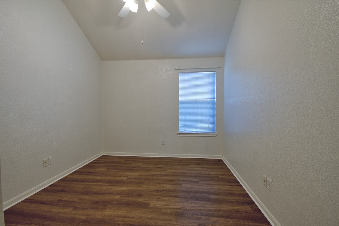 120 Greenside Lane Georgetown, TX 78633 - Photo 18 of 27 a view of an empty room with wooden floor and a window
