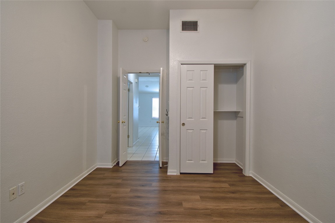 120 Greenside Lane Georgetown, TX 78633 - Photo 19 of 27 a view of an empty room with wooden floor and closet
