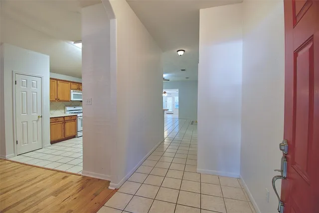 a view of a kitchen with a sink and a refrigerator