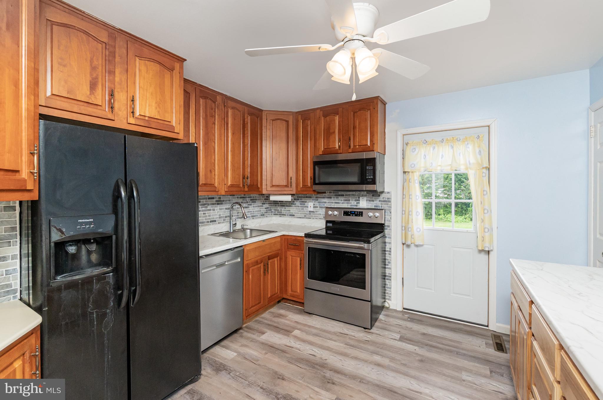 107 Jarmon Road Elkton, MD 21921 - Photo 12 of 33 a kitchen with stainless steel appliances granite countertop a refrigerator stove microwave and sink