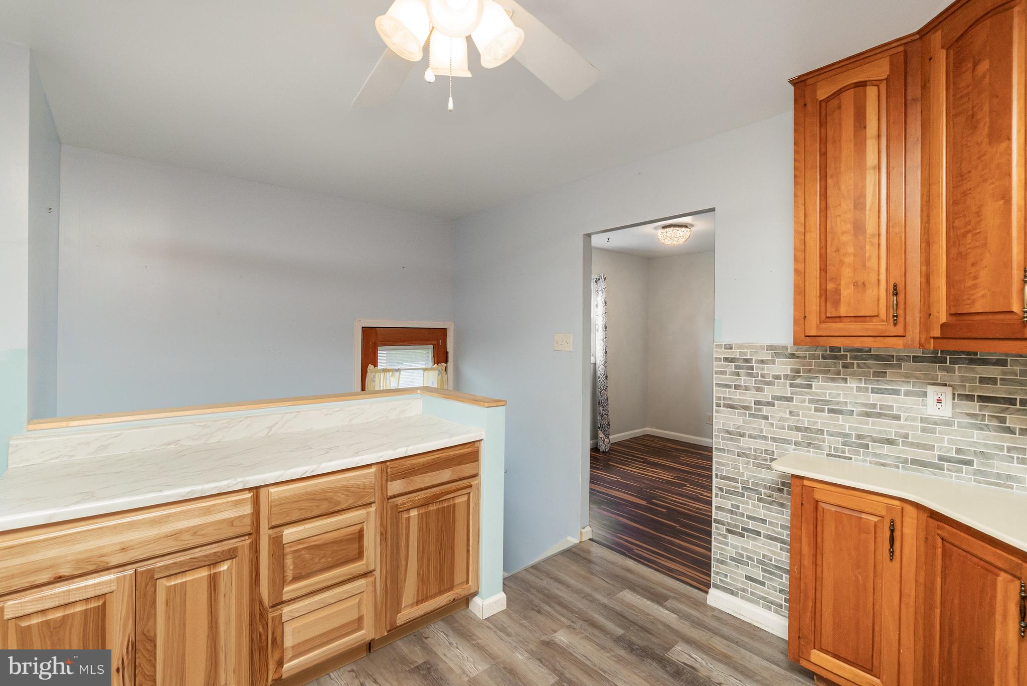 107 Jarmon Road Elkton, MD 21921 - Photo 14 of 33 a kitchen with granite countertop cabinets stainless steel appliances a sink and wooden floor