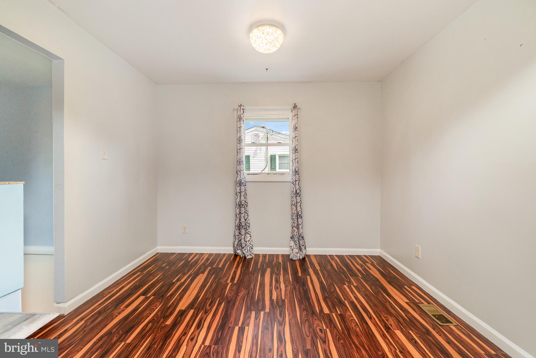 107 Jarmon Road Elkton, MD 21921 - Photo 8 of 33 an empty room with wooden floor and windows