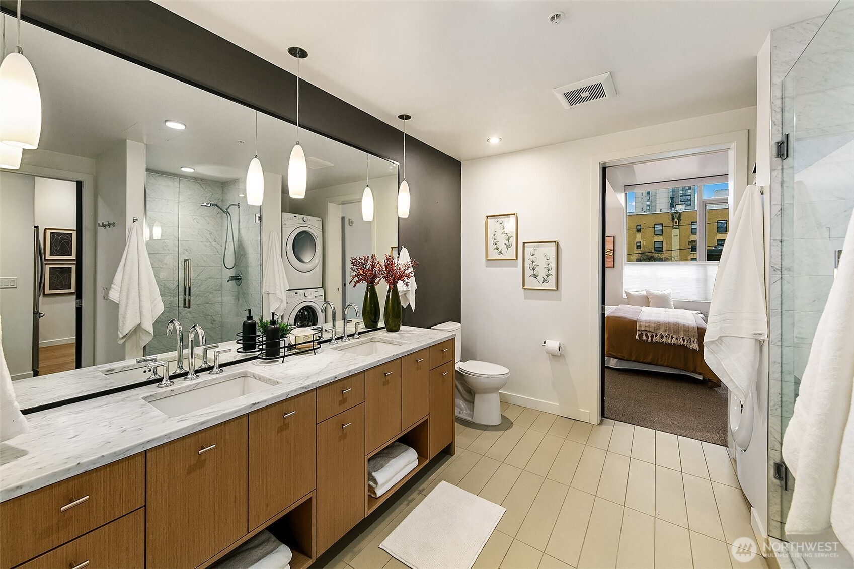 1321 Seneca Street, Unit 206 Seattle, WA 98101 - Photo 16 of 35 a spacious bathroom with a double vanity sink a mirror and a shower