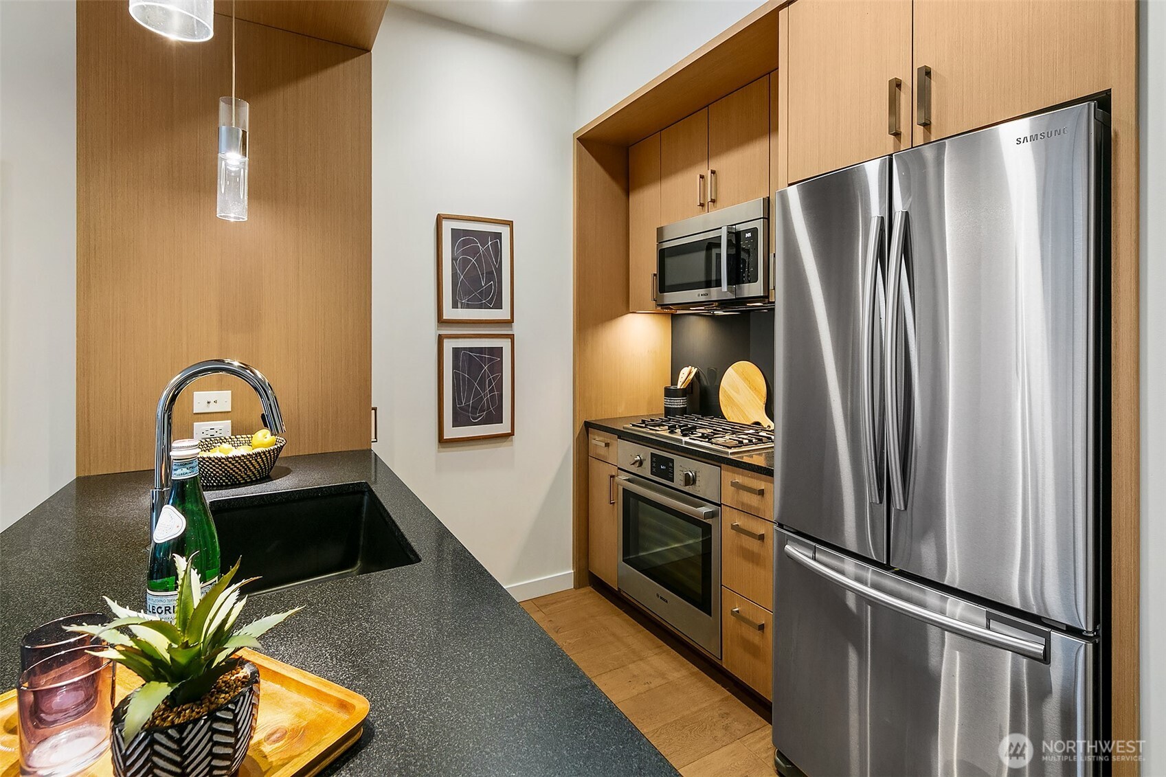 1321 Seneca Street, Unit 206 Seattle, WA 98101 - Photo 9 of 35 a kitchen with stainless steel appliances granite countertop a refrigerator and a stove