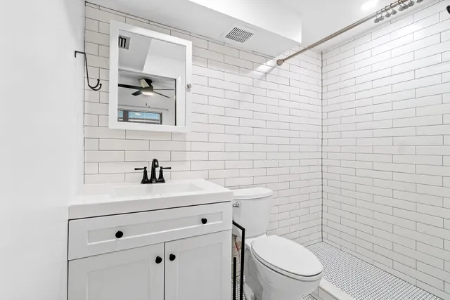 a bathroom with a toilet and a shower