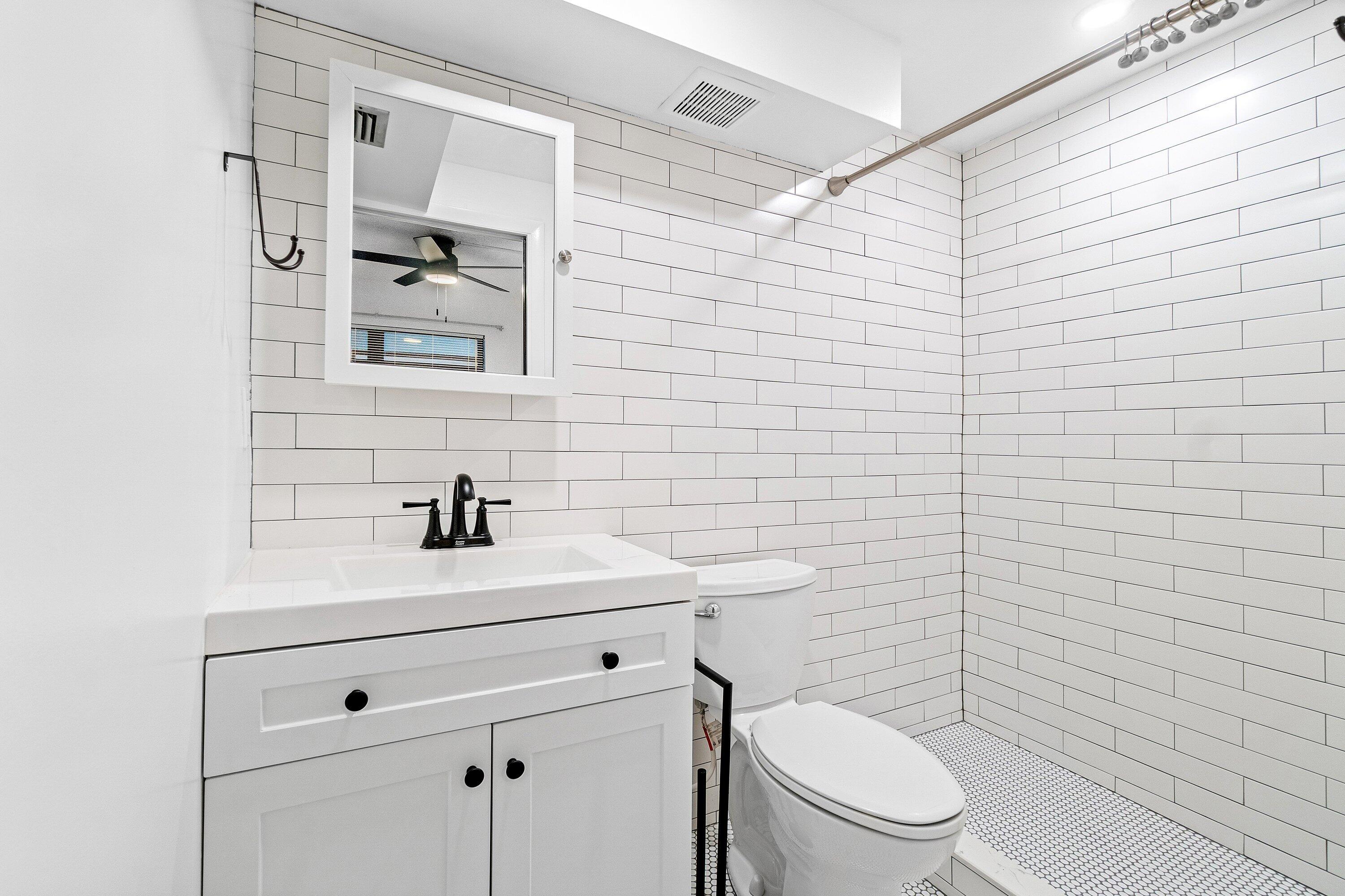 626 North Federal Highway, Unit 3 Lake Worth Beach, FL 33460 - Photo 15 of 23 a bathroom with a toilet sink vanity and mirror