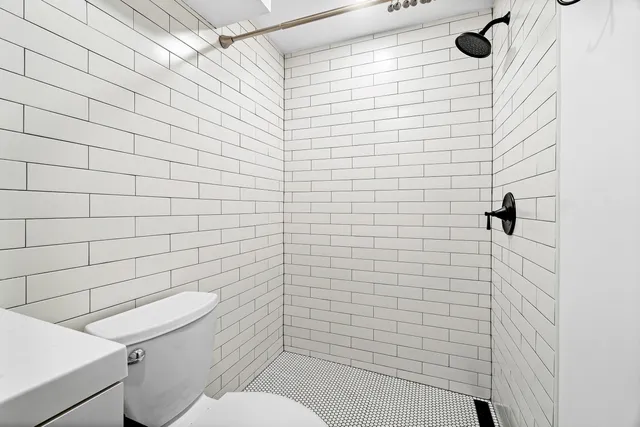 a view of bathroom with a sink a toilet and vanity