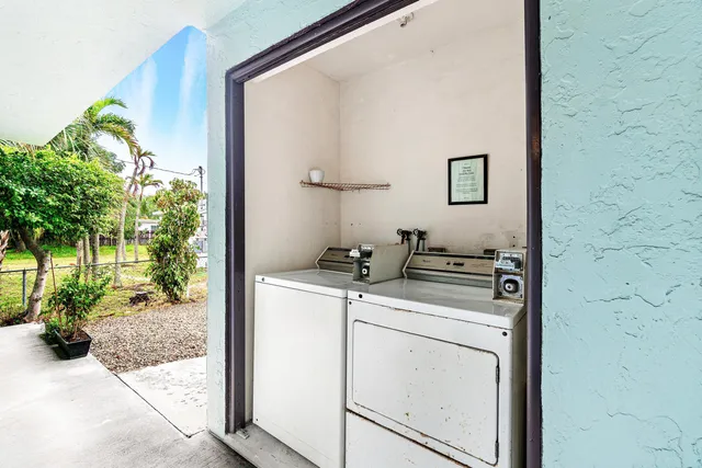a view of a house with a yard and potted plants