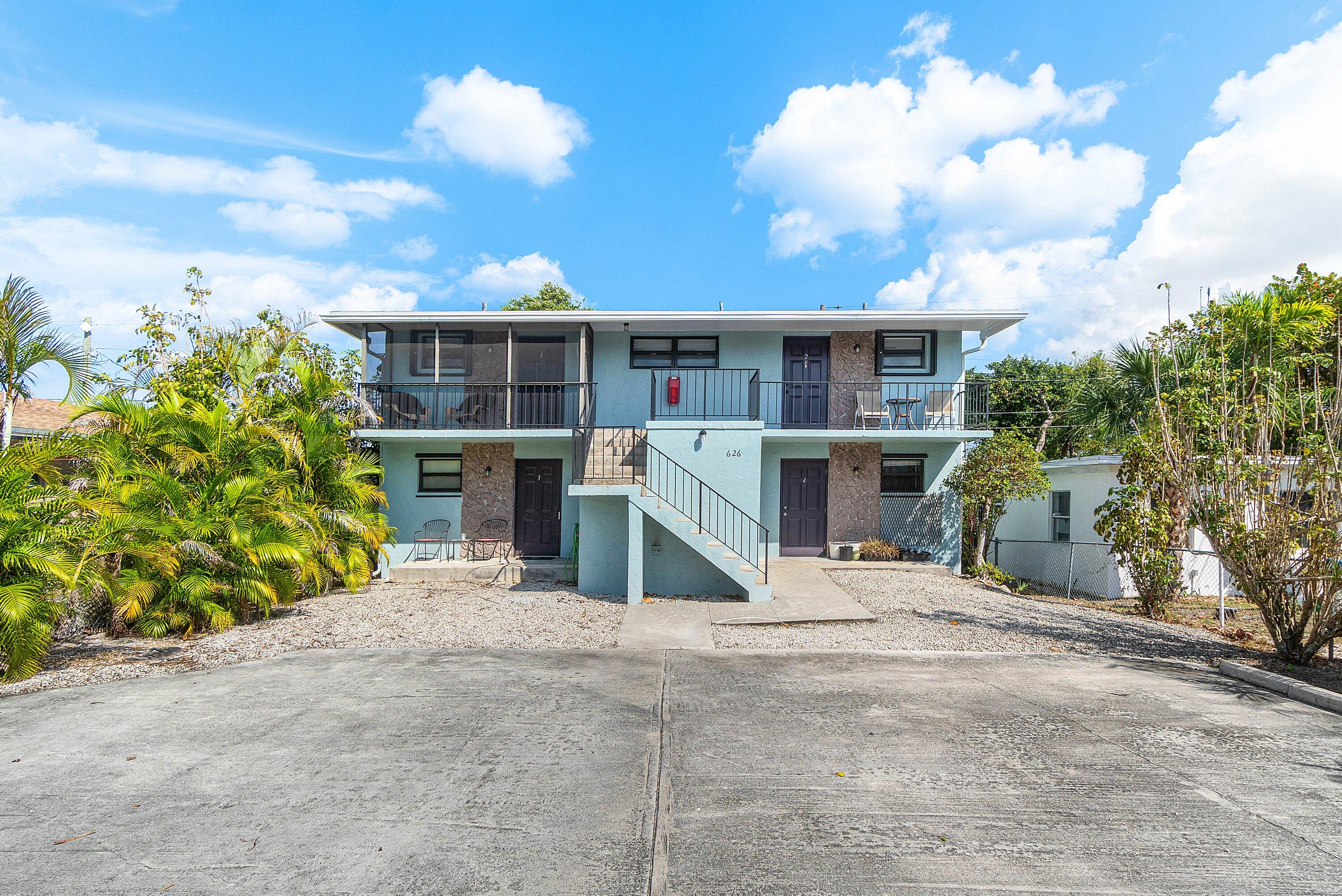 626 North Federal Highway, Unit 3 Lake Worth Beach, FL 33460 - Photo 21 of 23 a view of a house with a yard and potted plants