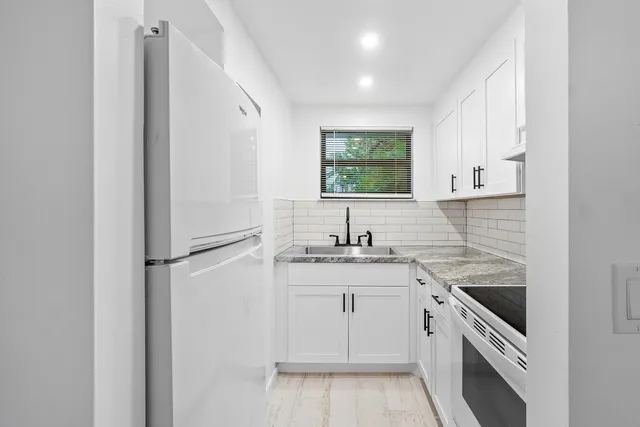 a white refrigerator freezer sitting inside of a kitchen