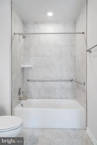 a bathroom with a bathtub and a toilet