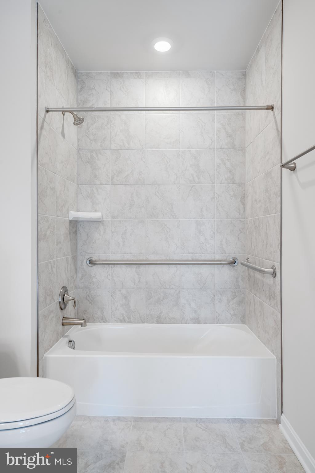 4003 Seaside Alder Road, Unit 101 DAISEY Bowie, MD 20720 - Photo 20 of 20 a bathroom with a bathtub and a toilet