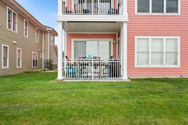 a view of a house with a yard and deck