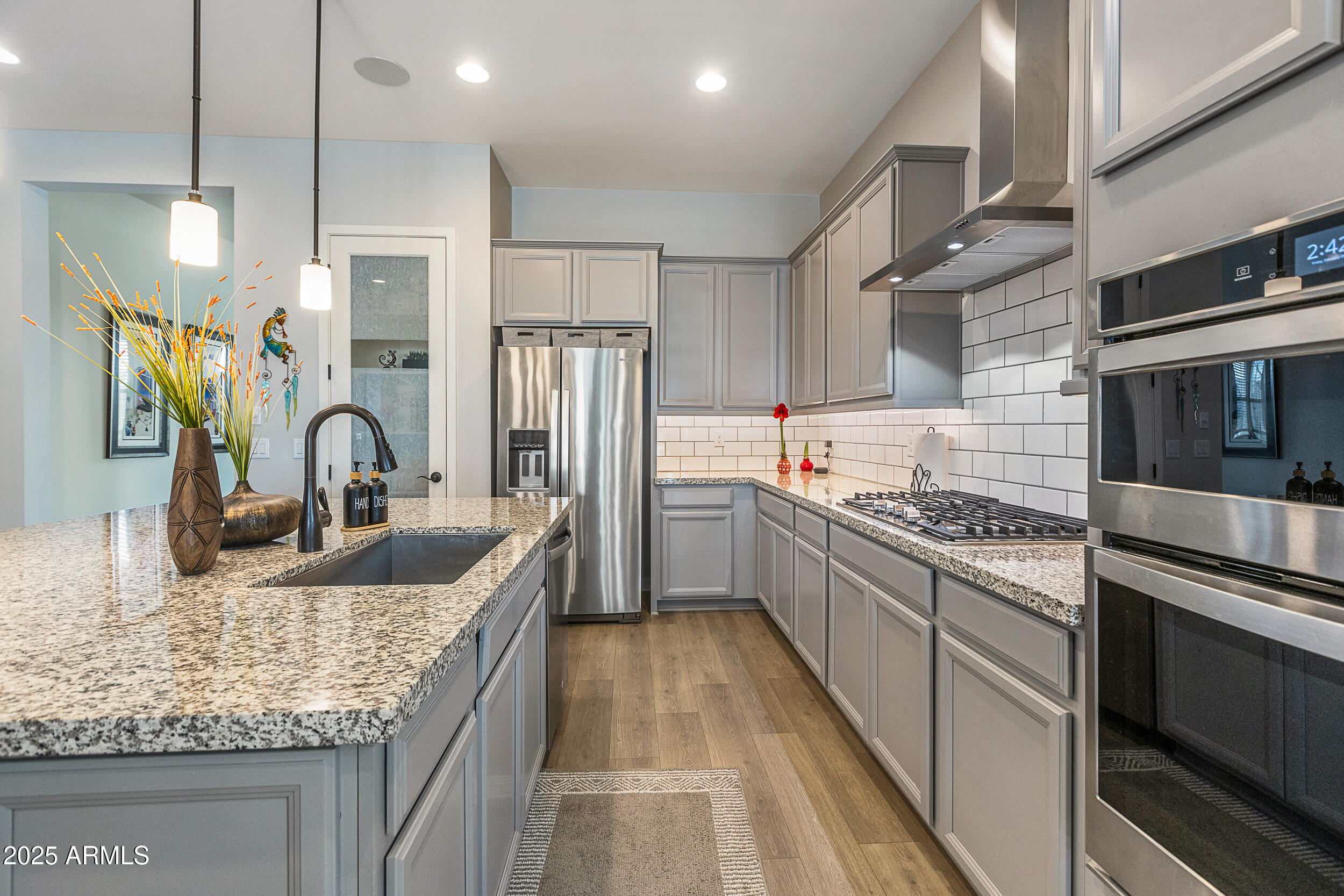 23030 East Estrella Road Queen Creek, AZ 85142 - Photo 12 of 47 a kitchen with stainless steel appliances granite countertop a sink stove and refrigerator