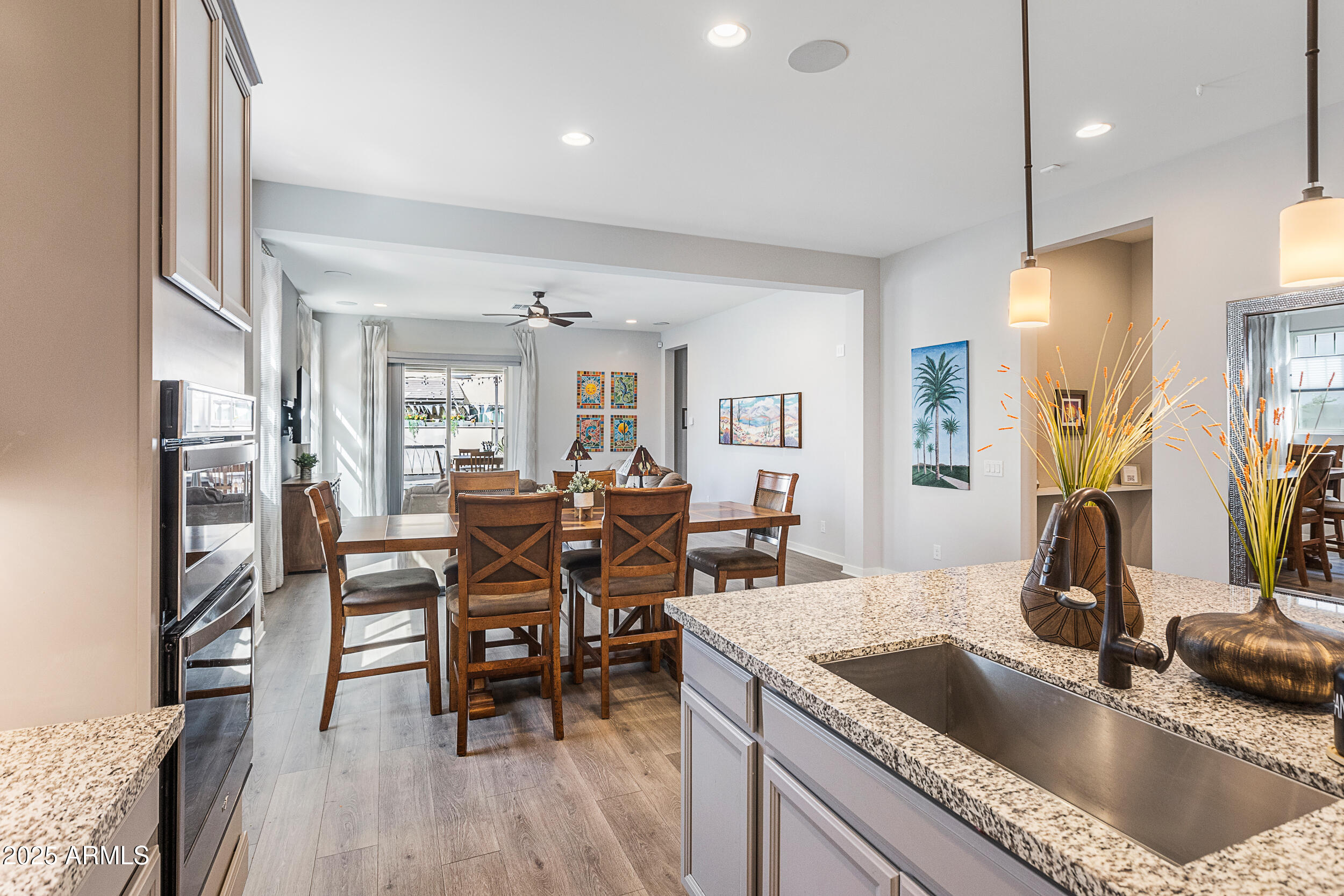 23030 East Estrella Road Queen Creek, AZ 85142 - Photo 15 of 47 a kitchen island with granite countertop a sink and a refrigerator