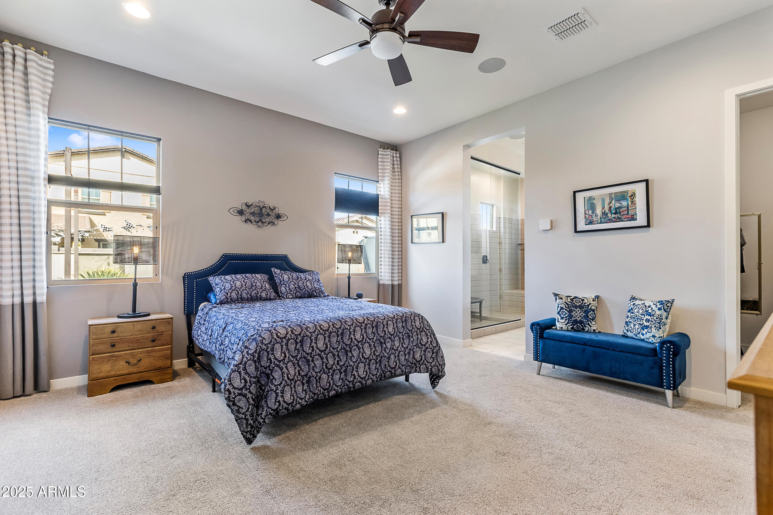 23030 East Estrella Road Queen Creek, AZ 85142 - Photo 26 of 47 a spacious bedroom with a bed window and couch