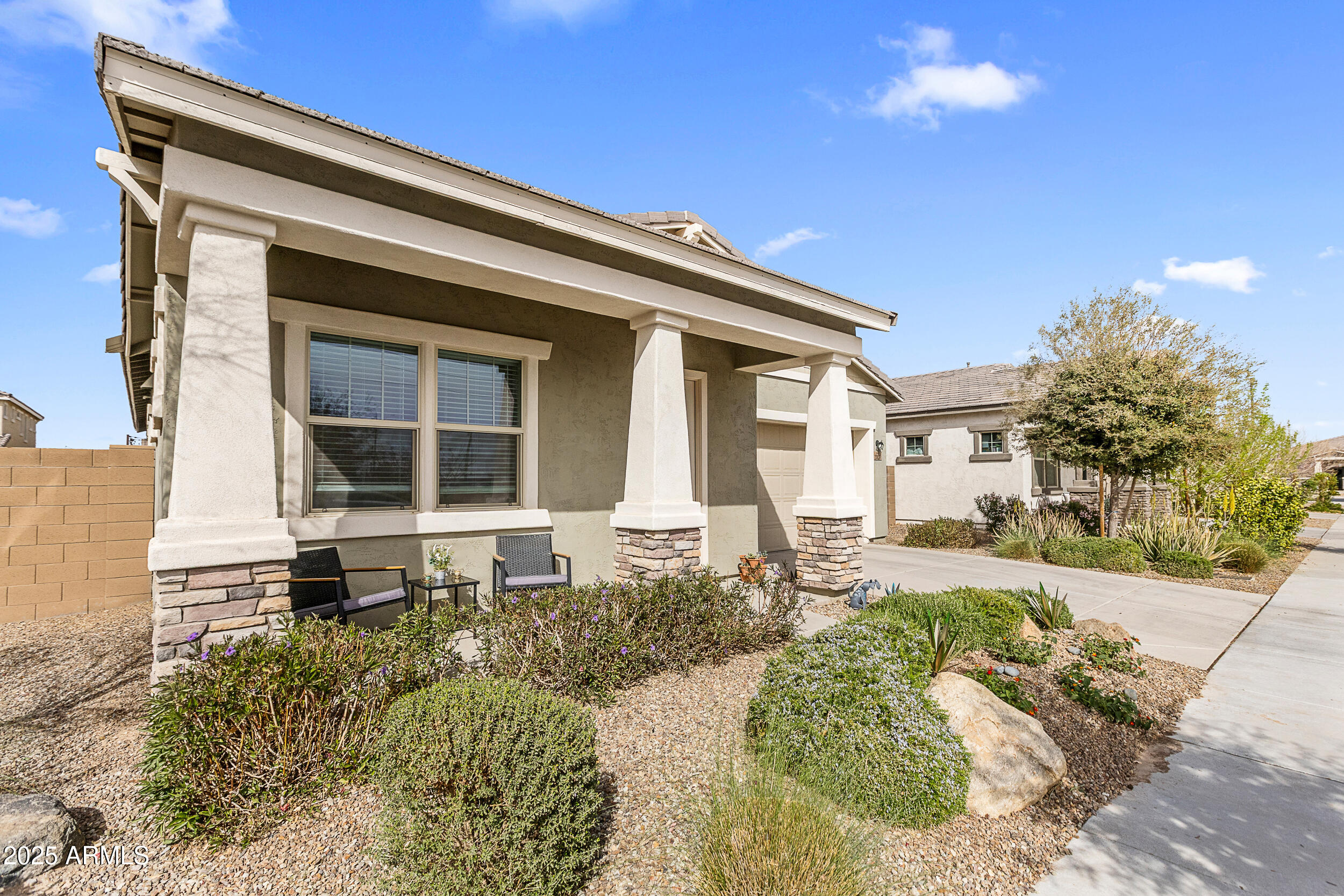 23030 East Estrella Road Queen Creek, AZ 85142 - Photo 3 of 47 a front view of a house with a yard