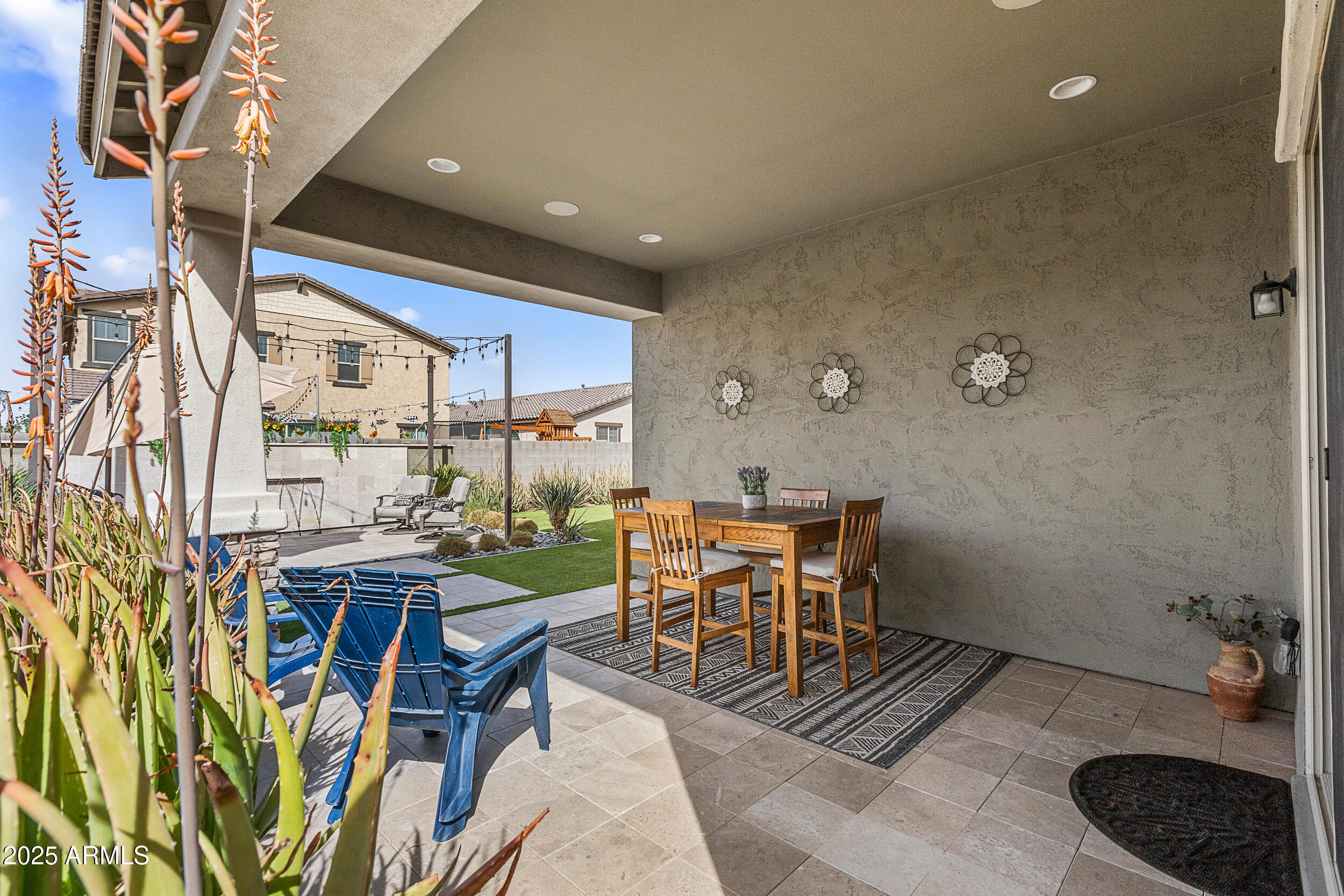 23030 East Estrella Road Queen Creek, AZ 85142 - Photo 31 of 47 a patio with a table and chairs