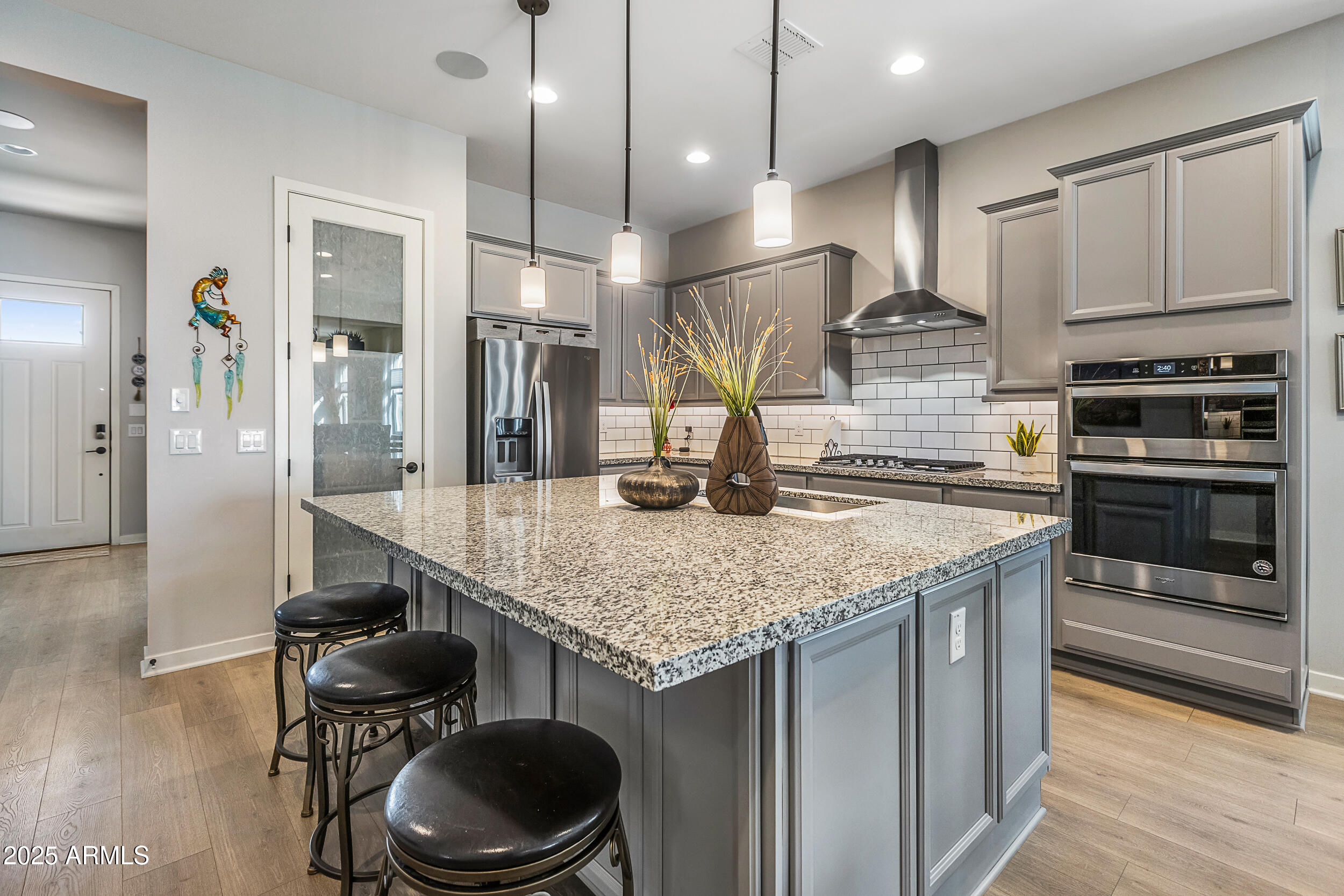23030 East Estrella Road Queen Creek, AZ 85142 - Photo 9 of 47 a kitchen with stainless steel appliances granite countertop a sink a stove and a refrigerator