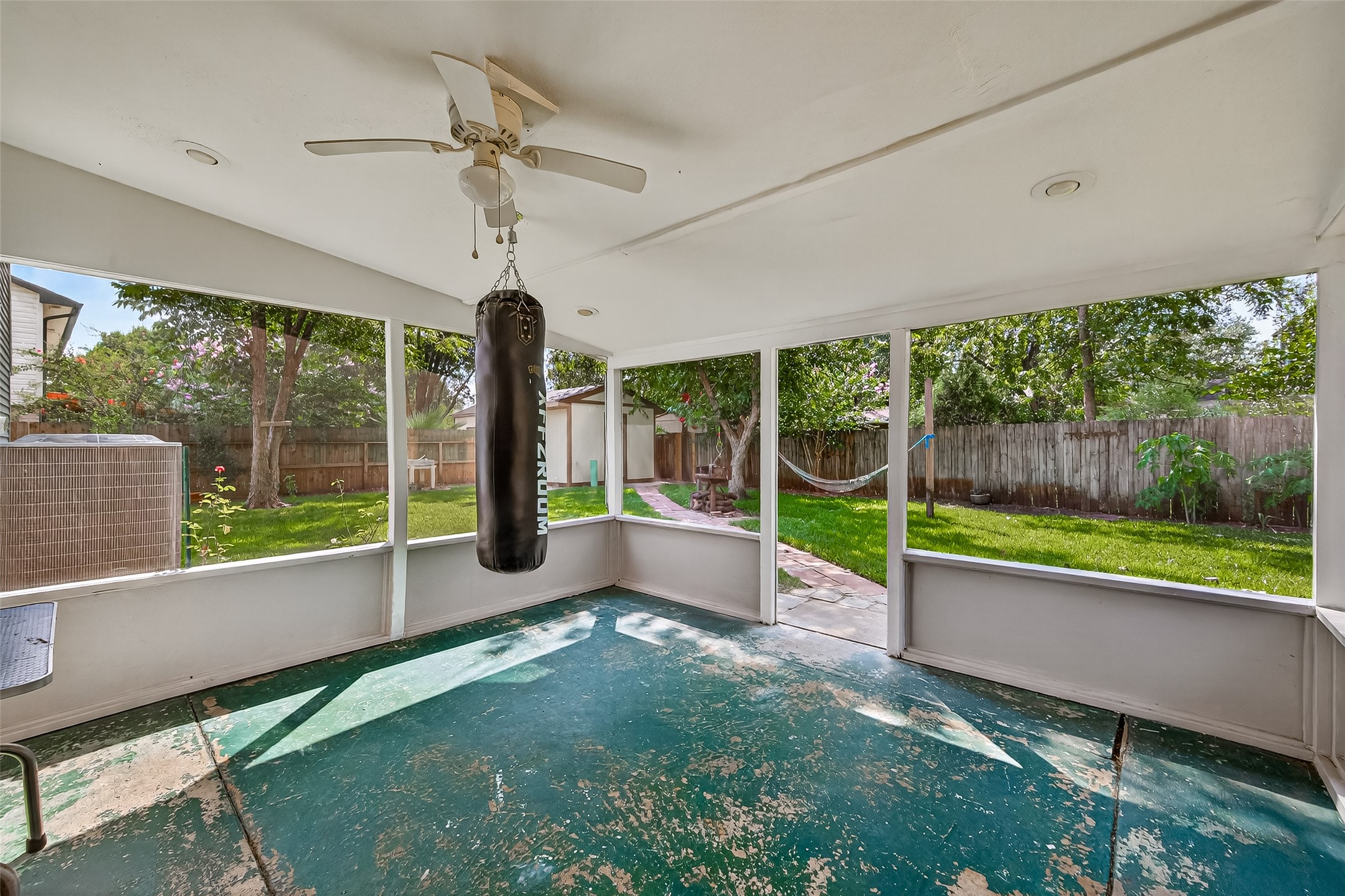 5323 Windsong Trail Houston, TX 77084 - Photo 25 of 30 Covered patio just out the back door looks out onto the massive backyard. Punching bag does not stay with the home.