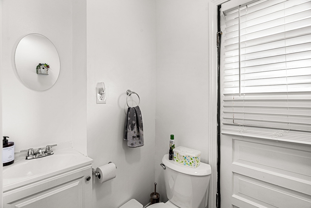 24 Hooper Street Chelsea, MA 02150 - Photo 11 of 15 a bathroom with a sink a toilet and a mirror
