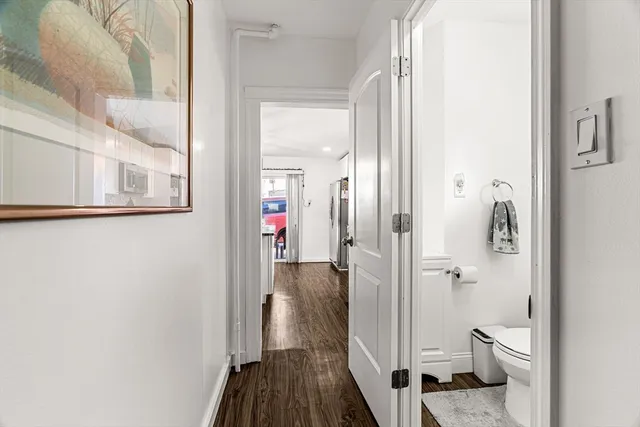 a bathroom with a granite countertop toilet and a shower