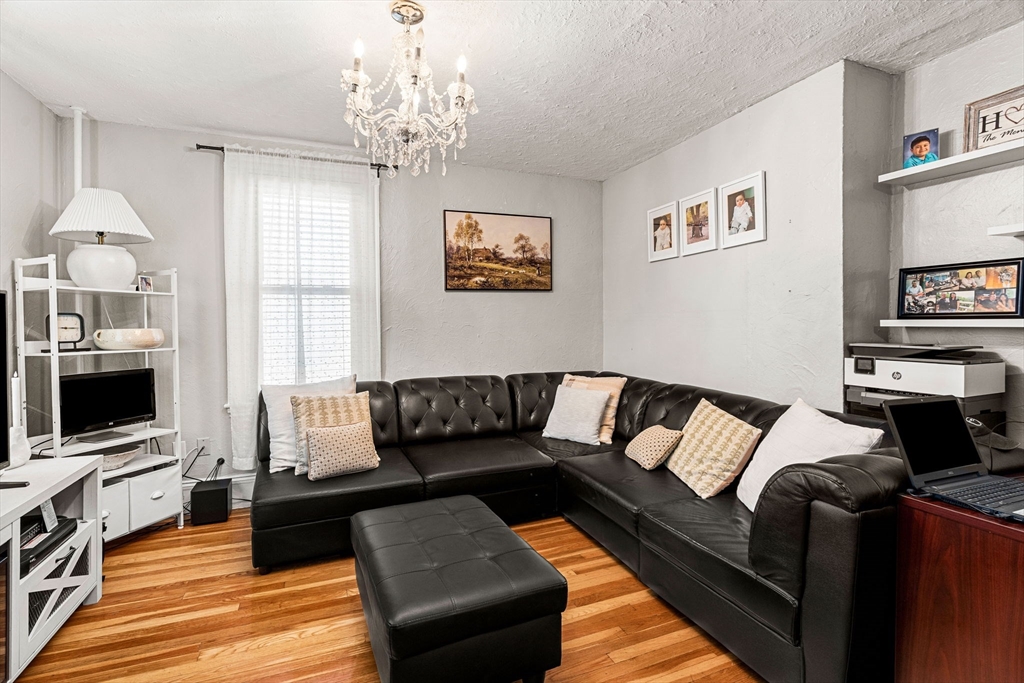 24 Hooper Street Chelsea, MA 02150 - Photo 13 of 15 a living room with furniture and a flat screen tv