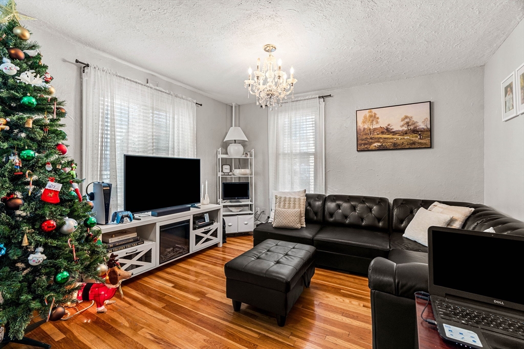 24 Hooper Street Chelsea, MA 02150 - Photo 14 of 15 a living room with furniture a flat screen tv and a christmas tree