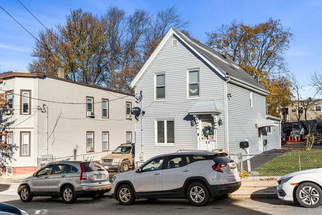 24 Hooper Street Chelsea, MA 02150 - Photo 3 of 15 a car parked in front of a white house
