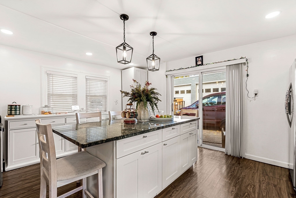24 Hooper Street Chelsea, MA 02150 - Photo 5 of 15 a kitchen with center island cabinets and wooden floor