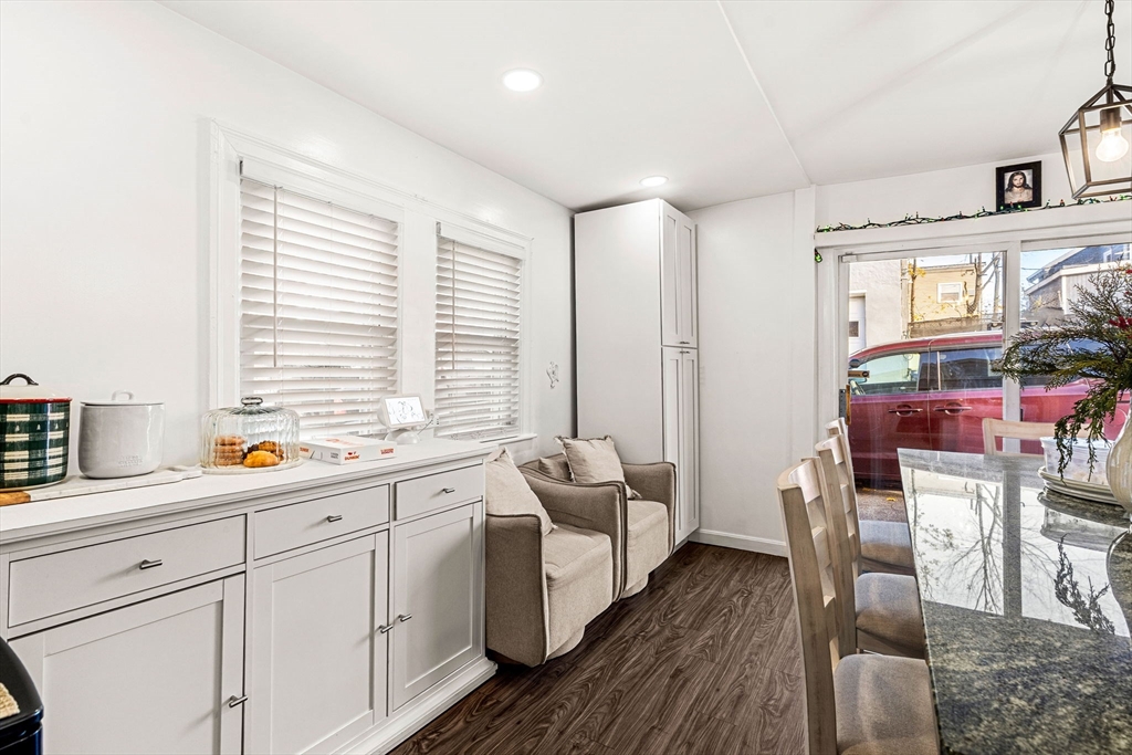 24 Hooper Street Chelsea, MA 02150 - Photo 9 of 15 a kitchen with stainless steel appliances sink cabinets and wooden floor