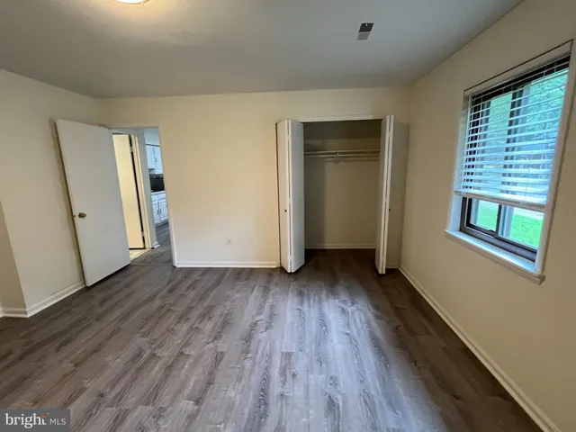 a view of a room with wooden floor and window