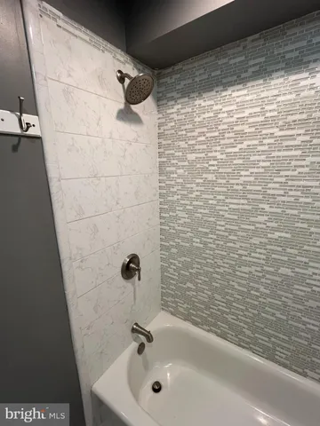 a bathroom with a shower and a sink
