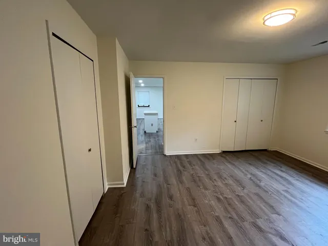 a view of a room with wooden floor and a sink